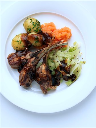 Individual portion of lamb ribs new potatoes cabbage and carrot swede mash Stock Photo - Rights-Managed, Code: 824-07585877