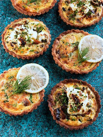 Individual smoked salmon tarts and goats cheese tarts Photographie de stock - Rights-Managed, Code: 824-07585878
