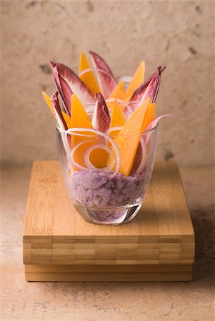 simsearch:652-05807656,k - Cream of Vitelotte potatoes with red chicory leaves and thin slices of Mimolette Foto de stock - Con derechos protegidos, Código: 825-05814083