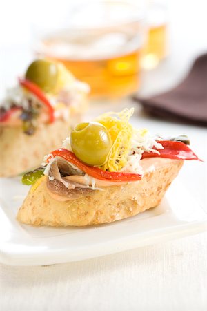 simsearch:825-06047693,k - Anchovy,egg ,red pepper and green olive on a bite-size slice of bread Stock Photo - Rights-Managed, Code: 825-05814215