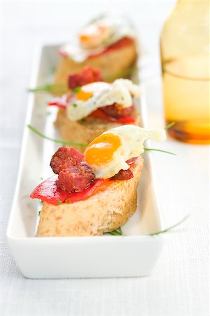 simsearch:652-03802623,k - Fried quail's eggs and Chorizo on a bite-size slice of bread Foto de stock - Con derechos protegidos, Código: 825-05814216