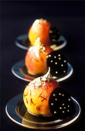 Saffron poached pears with round chocolate wafers Stock Photo - Rights-Managed, Code: 825-05811635