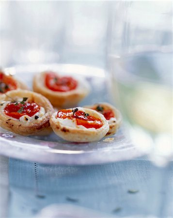 bite-sized goat's cheese and cherry tomato tarts Stock Photo - Rights-Managed, Code: 825-05986556