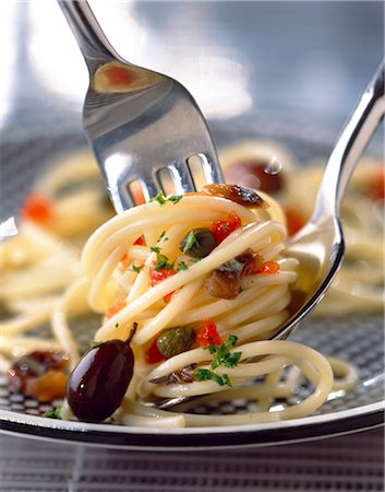 pasta and fork - spaghetti with tomatoes, capers and anchovies Stock Photo - Rights-Managed, Code: 825-05986833