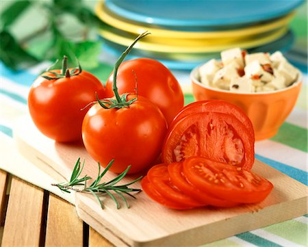 diced cheese - Whole and sliced tomatoes on chopping board Stock Photo - Rights-Managed, Code: 825-05988492