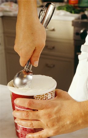 Taking a scoop of ice cream from the pot Stock Photo - Rights-Managed, Code: 825-06046275