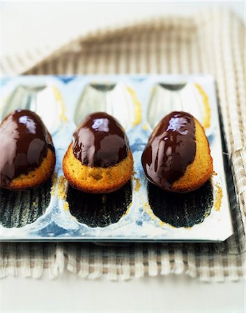 Madeleines coated with melted chocolate Stock Photo - Rights-Managed, Code: 825-06046736
