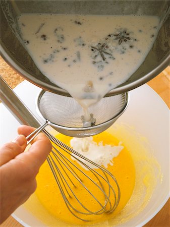 eggs milk - Adding the spicy milk to the egg yolks Stock Photo - Rights-Managed, Code: 825-06047522