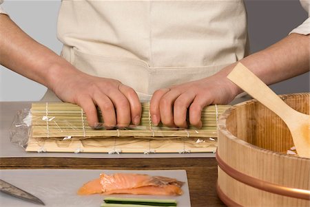 Cook rolling the rice in a mat for makis Stock Photo - Rights-Managed, Code: 825-06048727