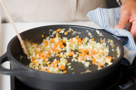 simsearch:825-06047515,k - Stirring the diced carrots and celery in a frying pan Foto de stock - Direito Controlado, Número: 825-06049429