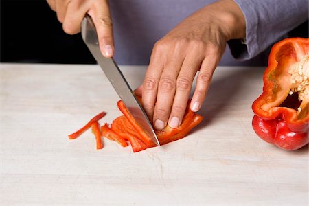 simsearch:825-07076592,k - Cutting the red pepper into strips Stock Photo - Rights-Managed, Code: 825-06049447