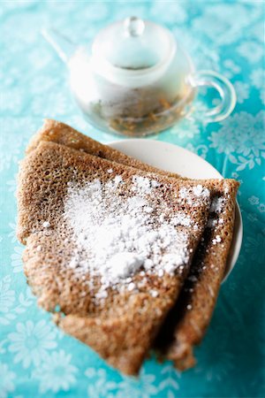 simsearch:652-03804838,k - Buckwheat pancake with icing sugar and a teapot Stock Photo - Rights-Managed, Code: 825-06049626