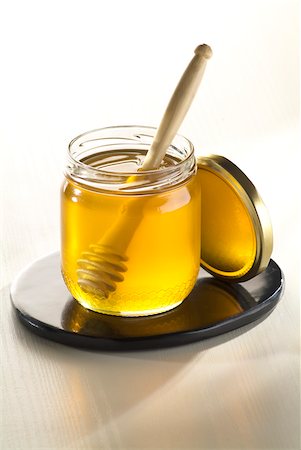 Jar of honey and wooden honey spoon Stock Photo - Rights-Managed, Code: 825-06049724