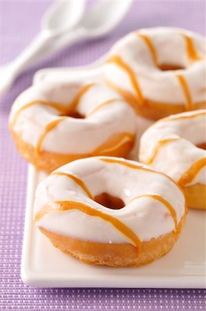 Donuts coated with icing sugar and caramel Stock Photo - Rights-Managed, Code: 825-06315043