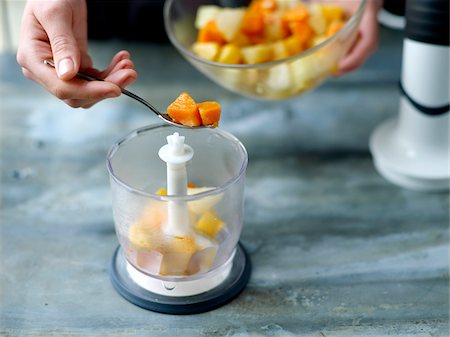 Placing the cooked vegetables in the bowl of a food processor Stock Photo - Rights-Managed, Code: 825-06316012