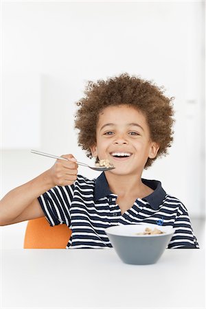 Boy eating a bowl of cereals Stock Photo - Rights-Managed, Code: 825-06316549