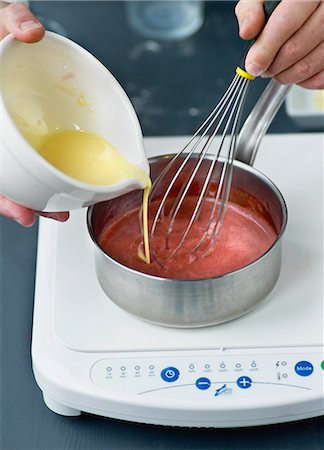 Adding the melted butter to the strawberry puree for the confectioner's custard Stock Photo - Rights-Managed, Code: 825-06815557