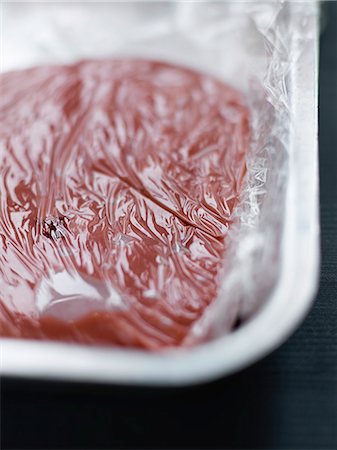 simsearch:652-05808734,k - Pouring the strawberry confectioner's cream into a hollow dish and cover with clingfilm Photographie de stock - Rights-Managed, Code: 825-06815559