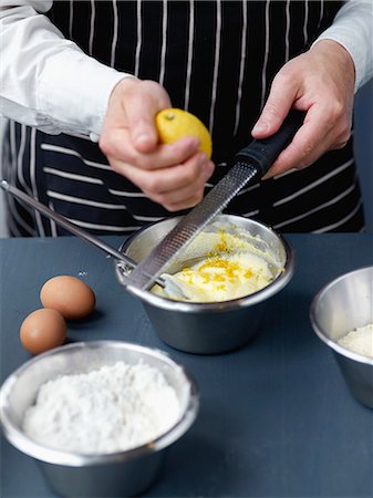 Adding the grated lemon zests to the cake dough Stock Photo - Rights-Managed, Code: 825-06815561