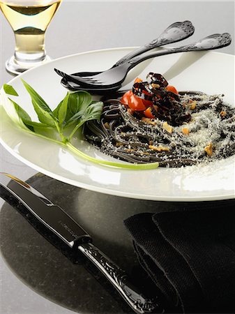 Squid ink spaghetti with purple peppers Stock Photo - Rights-Managed, Code: 825-06816406