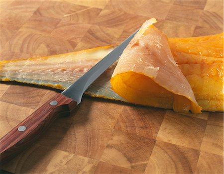 simsearch:825-06816490,k - Taking the skin off a smoked haddock Photographie de stock - Rights-Managed, Code: 825-07075792