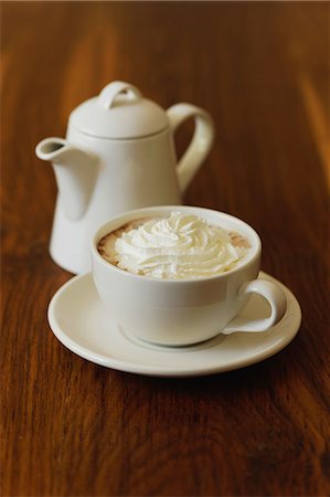 Cup of hot chocolate topped with whipped cream and chocolate pot Foto de stock - Con derechos protegidos, Código: 825-07077060