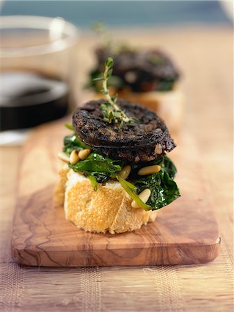 simsearch:825-07077705,k - Blood sausage,spinach,raisin and pine nut crostini Stock Photo - Rights-Managed, Code: 825-07077678