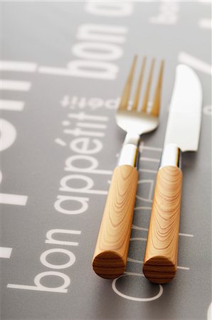 Knife and fork on a table with the inscription "Bon appetit" Stock Photo - Rights-Managed, Code: 825-07077983