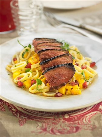 simsearch:825-07522758,k - Pasta salad with pomegranate seeds,mango and thinly sliced duck magret Stock Photo - Rights-Managed, Code: 825-07522281