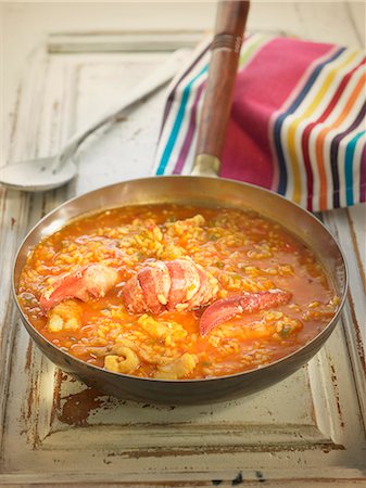 Rice in tomato sauce with lobster,squid and hake Stockbilder - Lizenzpflichtiges, Bildnummer: 825-07522297