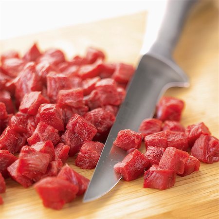 simsearch:825-06817272,k - Chopping the raw meat into small pieces Stock Photo - Rights-Managed, Code: 825-07522404