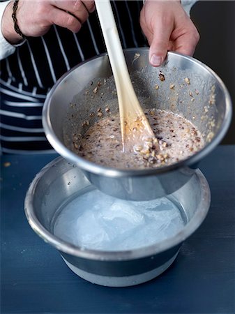 simsearch:825-07649104,k - Placing the bowl of mixture in a bigger bowl full of freezing water Stock Photo - Rights-Managed, Code: 825-07652749