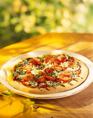 Goat's cheese,cherry tomato and basil pizza Stock Photo - Rights-Managed, Code: 825-02304264