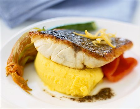 Piece of grilled bass with mashed potatoes and courgette flower Stock Photo - Rights-Managed, Code: 825-02304582