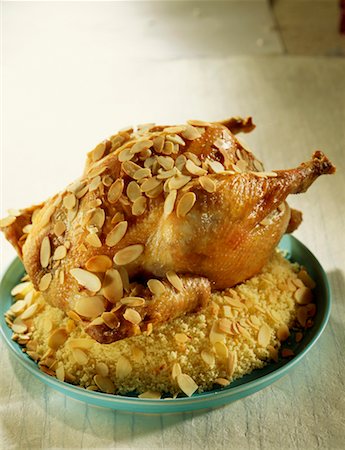 Poulet rôti farci aux amandes et couscous Photographie de stock - Rights-Managed, Code: 825-02307129
