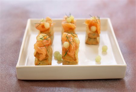 Smoked salmon on madeleines with herbs and grapes Stock Photo - Rights-Managed, Code: 825-02307546