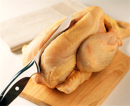 raw chicken on cutting board - cutting raw chicken Stock Photo - Rights-Managed, Code: 825-02303850