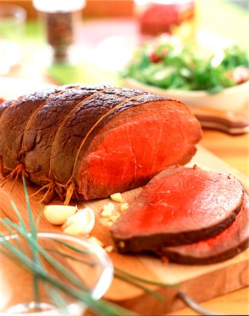 red meat - Sliced roast beef on a chopping-board Stock Photo - Rights-Managed, Code: 825-03627245