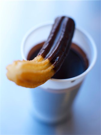 Churros covered in melted chocolate Stock Photo - Rights-Managed, Code: 825-03629518