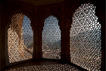 Looking through stone lattice window to the walls of Amber Fort; Amer, Jaipur, India Stock Photo - Rights-Managed, Code: 832-08007570