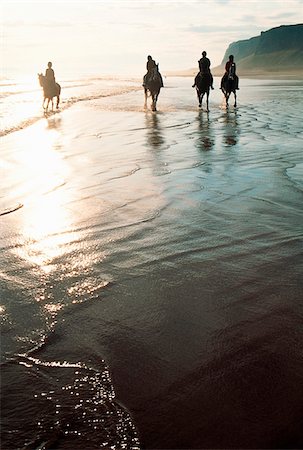 Four people horseback riding on a coastal beach, Ireland Stock Photo - Rights-Managed, Code: 832-03232158