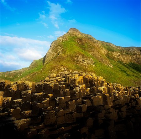 Basalt rock formations near a mountain, Giant's Causeway, County Antrim, Northern Ireland Stock Photo - Rights-Managed, Code: 832-03232218