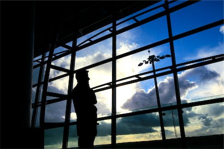 people airports silhouettes - Cork City, County Cork, Ireland; Silhouette of man at airport window Stock Photo - Rights-Managed, Code: 832-03233341