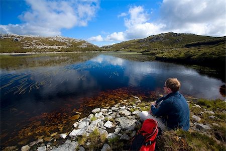 donegal - Aghla Mountain, Co Donegal, Ireland;  Man resting beside a mountain pool Foto de stock - Con derechos protegidos, Código: 832-03233713