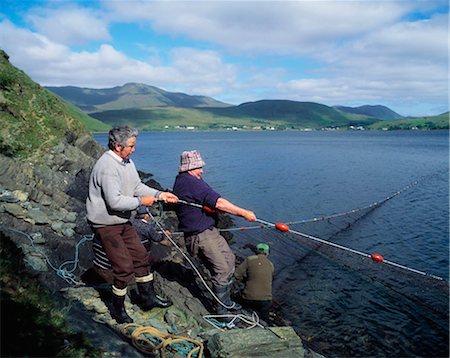 Leenane Village, Co Galway, Ireland; Men Hauling In A Large Fishing Net Foto de stock - Con derechos protegidos, Código: 832-03640171