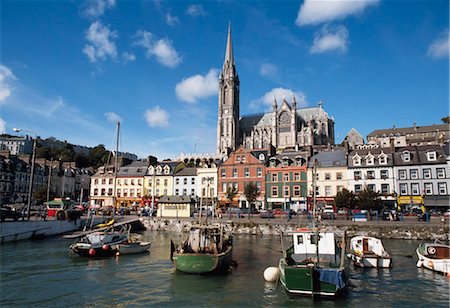 Cobh, Co Cork, Ireland; View Of Fishing Boats In Harbour With A View Of St. Colman's Cathedral Foto de stock - Con derechos protegidos, Código: 832-03640383