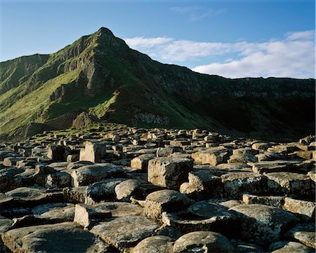 Giant's Causeway,Co Antrim,Northern Ireland;Basalt Columns And Green Hills Stock Photo - Rights-Managed, Code: 832-03640581