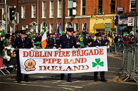 simsearch:832-03639747,k - Dublin, Ireland; Men Holding A Sign 'dublin Fire Brigade Pipe Band Ireland' As They Go Down O'connell Street Stock Photo - Rights-Managed, Code: 832-03640984