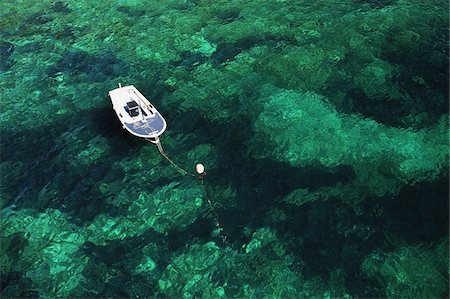 Boat moored in green sea Stock Photo - Rights-Managed, Code: 832-03724008