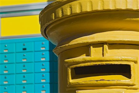 post office - Yellow post box and turquoise PO boxes Stock Photo - Rights-Managed, Code: 832-03724106